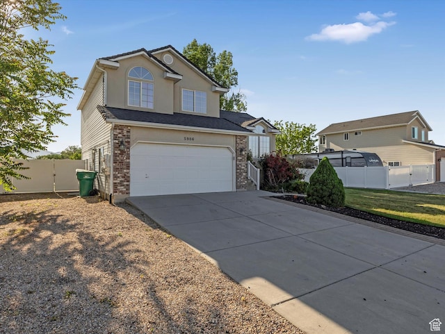 5986 S 4250 W, Roy, UT 84067 - traditional-style house featuring concrete driveway, an attached garage, and a gate