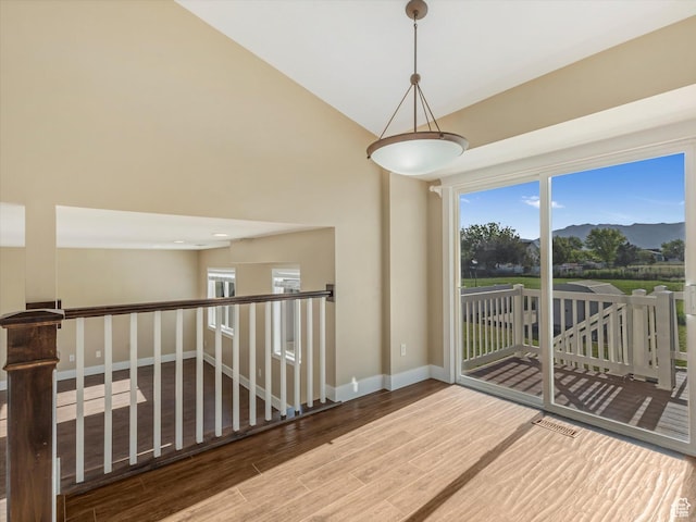 5986 S 4250 W, Roy, UT 84067 - spare room featuring wood finished floors, baseboards, a mountain view, and lofted ceiling