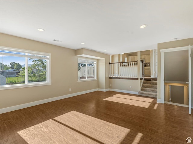 5986 S 4250 W, Roy, UT 84067 - unfurnished living room with wood finished floors, baseboards, stairway, and recessed lighting