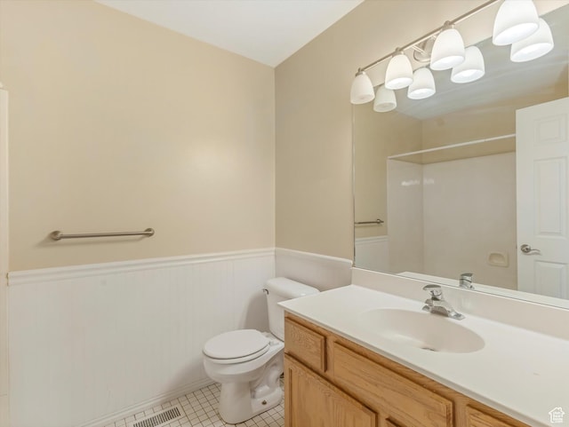 5986 S 4250 W, Roy, UT 84067 - bathroom with wainscoting, toilet, vanity, tile patterned floors, and a shower