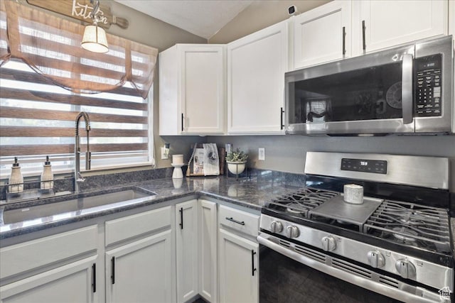 1158 N 2675 W, Layton, UT 84041 - kitchen featuring stainless steel appliances, a sink, white cabinets, lofted ceiling, and dark stone countertops