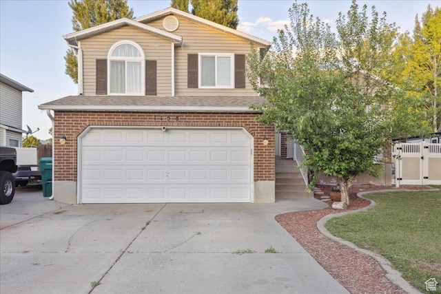1158 N 2675 W, Layton, UT 84041 - view of front of house featuring brick siding, a garage, concrete driveway, roof with shingles, and a gate