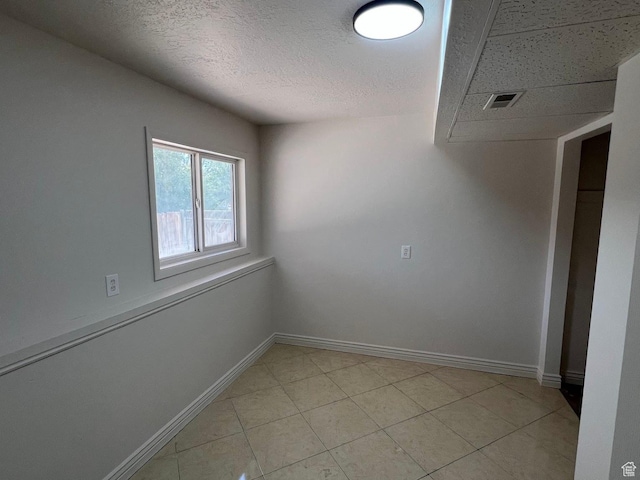 3722 S 8235 W, Magna, UT 84044 - unfurnished room with baseboards, a textured ceiling, and light tile patterned floors