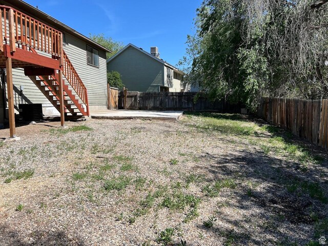3722 S 8235 W, Magna, UT 84044 - fenced backyard featuring stairs and a wooden deck