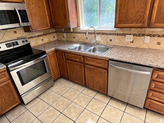 3722 S 8235 W, Magna, UT 84044 - kitchen featuring stainless steel appliances, a sink, light tile patterned floors, and tasteful backsplash