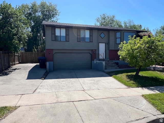 3722 S 8235 W, Magna, UT 84044 - raised ranch with a garage, brick siding, and driveway