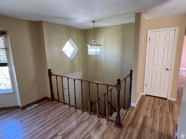 3722 S 8235 W, Magna, UT 84044 - stairway with wood finished floors, a chandelier, healthy amount of natural light, and baseboards