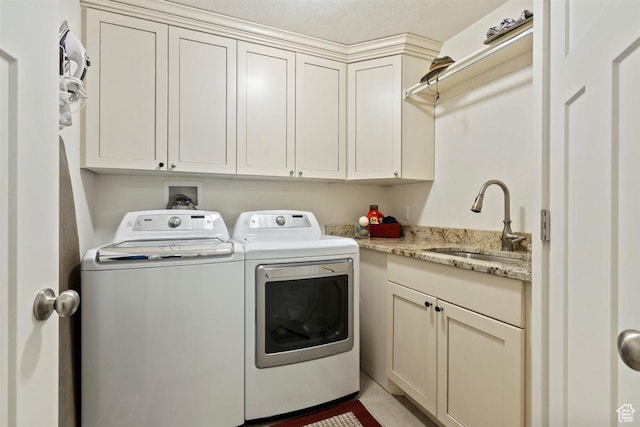 1097 E Highline Rd, Lake Point, UT 84074 - laundry room featuring washing machine and dryer, cabinet space, and light tile patterned floors