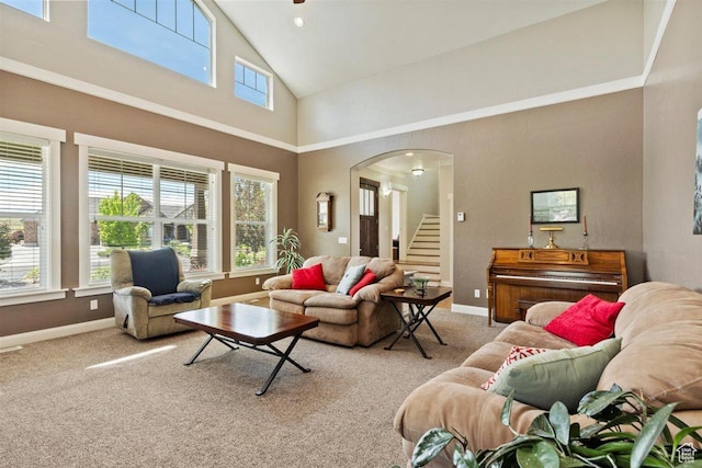 1097 E Highline Rd, Lake Point, UT 84074 - living area featuring high vaulted ceiling, healthy amount of natural light, stairs, carpet floors, and arched walkways