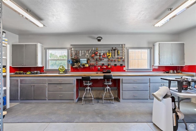 1097 E Highline Rd, Lake Point, UT 84074 - kitchen featuring gray cabinetry, a textured ceiling, and light countertops