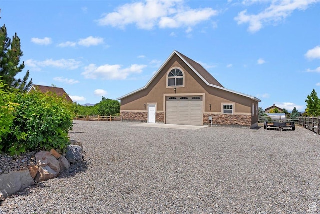 1097 E Highline Rd, Lake Point, UT 84074 - view of home's exterior with stone siding, stucco siding, and a garage