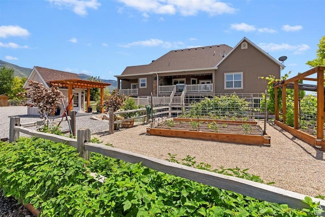 1097 E Highline Rd, Lake Point, UT 84074 - rear view of property featuring a vegetable garden, a pergola, and stucco siding