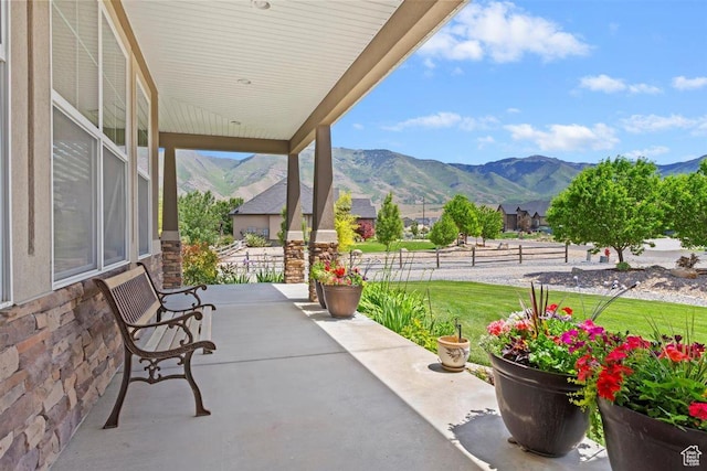 1097 E Highline Rd, Lake Point, UT 84074 - porch featuring a mountain view and a lawn