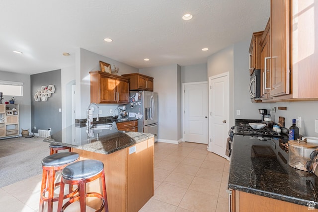 2869 W Chestnut St, Lehi, UT 84043 - kitchen featuring appliances with stainless steel finishes, a sink, a peninsula, brown cabinetry, and a kitchen bar