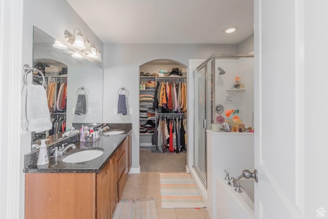 2869 W Chestnut St, Lehi, UT 84043 - full bathroom featuring a spacious closet, a stall shower, double vanity, and tile patterned floors
