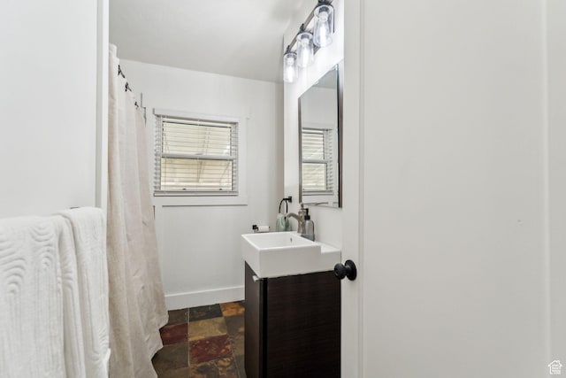 2578 E 2940 S, Salt Lake City, UT 84109 - full bathroom featuring vanity, baseboards, and stone finish flooring