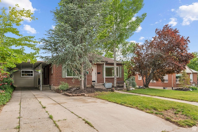 2578 E 2940 S, Salt Lake City, UT 84109 - view of front of property with concrete driveway, brick siding, a carport, a front yard, and entry steps