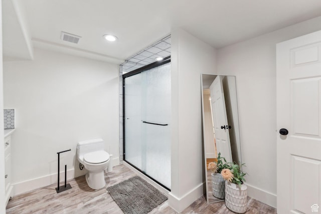 2578 E 2940 S, Salt Lake City, UT 84109 - bathroom with toilet, wood finished floors, a shower stall, baseboards, and recessed lighting