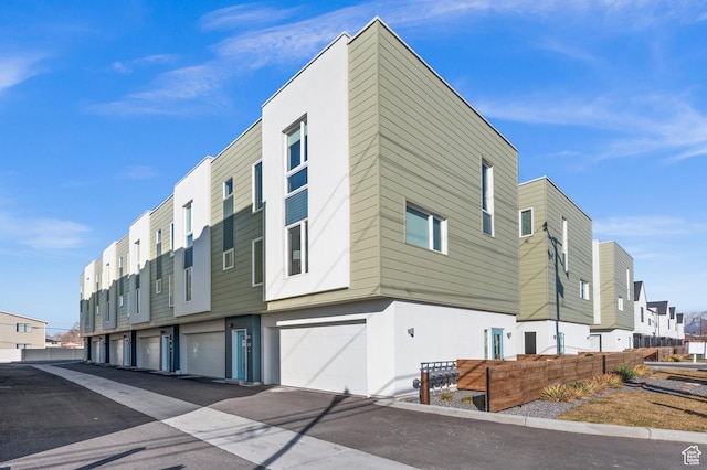 1034 W 1700 S Unit 121, Salt Lake City, UT 84104 - view of building exterior featuring a residential view and a garage