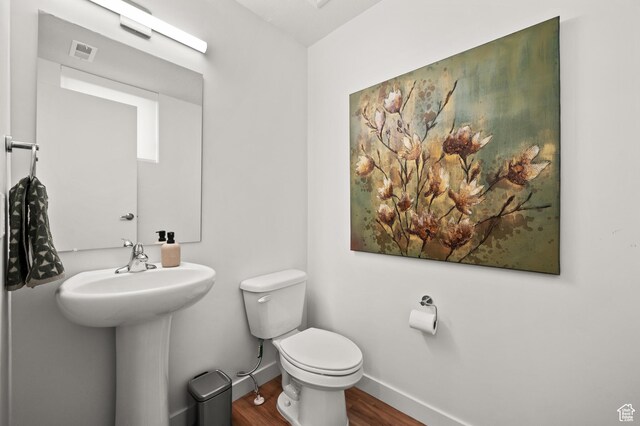 1034 W 1700 S Unit 121, Salt Lake City, UT 84104 - half bathroom featuring wood finished floors, toilet, and baseboards