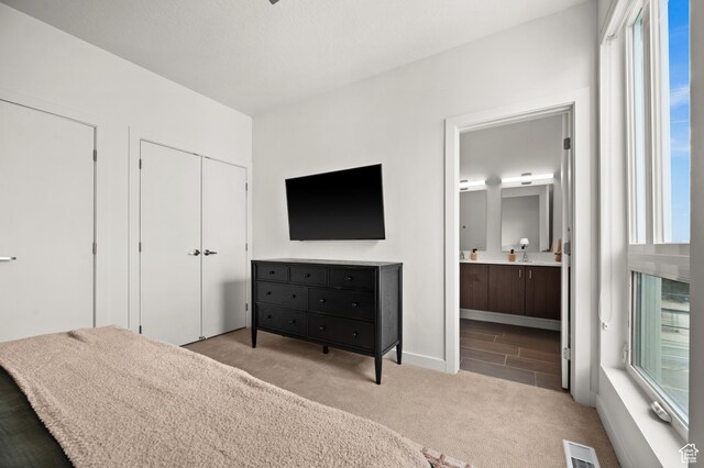 1034 W 1700 S Unit 121, Salt Lake City, UT 84104 - carpeted bedroom with ensuite bathroom and baseboards