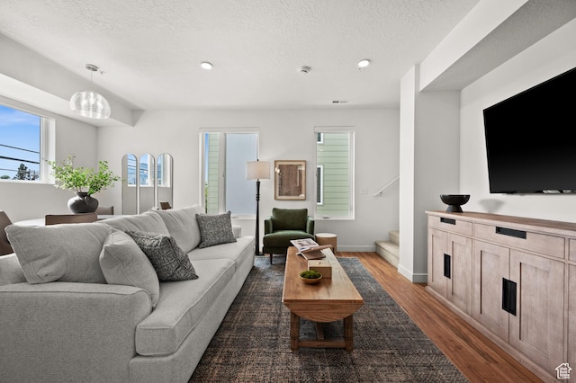 1034 W 1700 S Unit 121, Salt Lake City, UT 84104 - living room featuring dark wood-style floors, stairs, a textured ceiling, recessed lighting, and baseboards