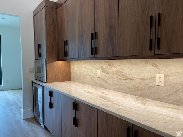 101 Crestview Cir, Park City, UT 84098 - kitchen with decorative backsplash, beverage cooler, light countertops, light wood-style floors, and baseboards