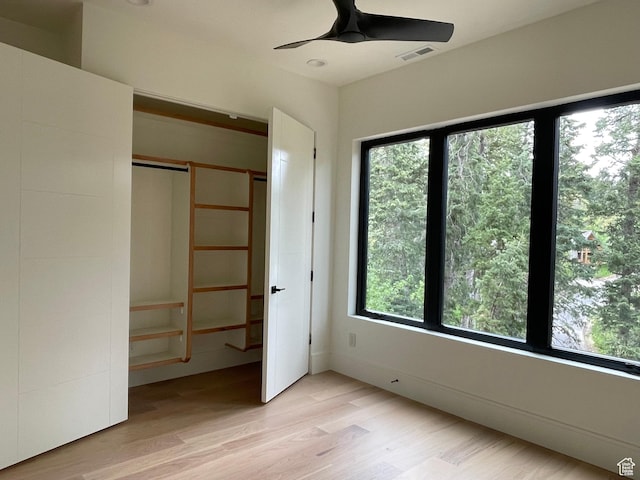 101 Crestview Cir, Park City, UT 84098 - unfurnished bedroom featuring multiple windows, light wood-style floors, a closet, and ceiling fan
