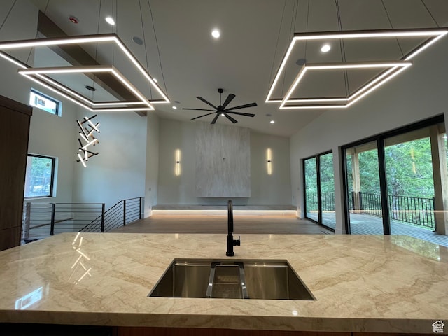 101 Crestview Cir, Park City, UT 84098 - kitchen with a sink, recessed lighting, open floor plan, light stone countertops, and a towering ceiling