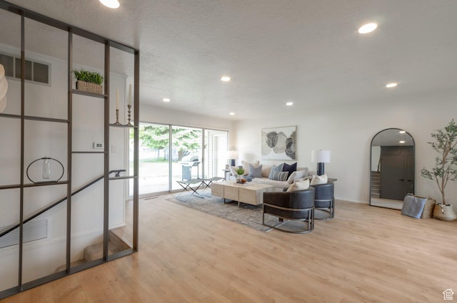 1416 N Eyrie Dr E, Ogden, UT 84404 - living area featuring light wood-style flooring, recessed lighting, baseboards, and a textured ceiling