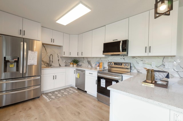 1416 N Eyrie Dr E, Ogden, UT 84404 - kitchen featuring appliances with stainless steel finishes, a sink, light stone counters, light wood finished floors, and white cabinets