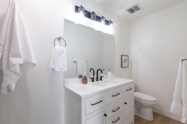 1416 N Eyrie Dr E, Ogden, UT 84404 - bathroom with vanity, toilet, baseboards, and wood finished floors