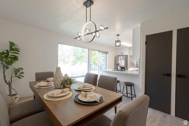 1416 N Eyrie Dr E, Ogden, UT 84404 - dining room featuring a chandelier and light wood-style flooring