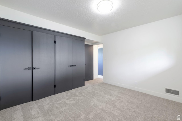 1416 N Eyrie Dr E, Ogden, UT 84404 - unfurnished bedroom featuring carpet flooring, a closet, baseboards, and a textured ceiling