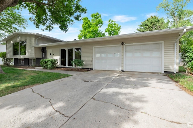 1416 N Eyrie Dr E, Ogden, UT 84404 - split level home featuring an attached garage, driveway, and a front lawn