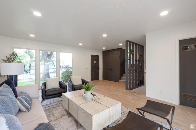 1416 N Eyrie Dr E, Ogden, UT 84404 - living room featuring stairs, light wood finished floors, and recessed lighting