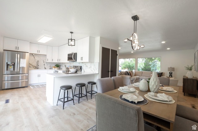 1416 N Eyrie Dr E, Ogden, UT 84404 - dining space with light wood-style floors, a chandelier, and recessed lighting