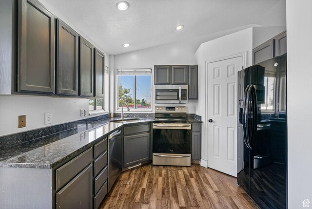3774 S 8370 W, Magna, UT 84044 - kitchen featuring appliances with stainless steel finishes, a sink, dark wood finished floors, recessed lighting, and dark stone counters