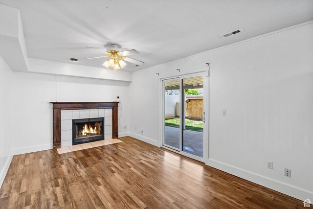 3774 S 8370 W, Magna, UT 84044 - unfurnished living room featuring wood finished floors, baseboards, a ceiling fan, and a fireplace