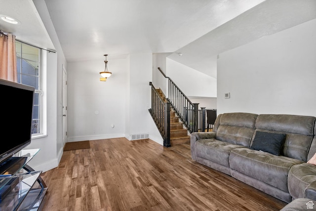 3774 S 8370 W, Magna, UT 84044 - living room featuring stairs, wood finished floors, and baseboards