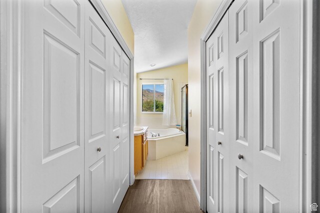 3774 S 8370 W, Magna, UT 84044 - hall with vaulted ceiling, dark wood-style flooring, and a textured ceiling