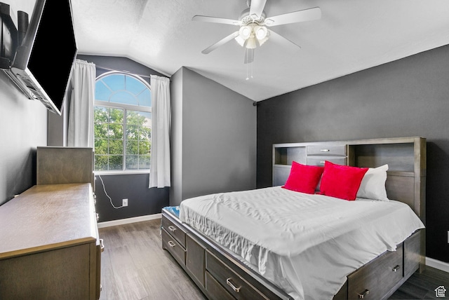 3774 S 8370 W, Magna, UT 84044 - bedroom featuring vaulted ceiling, wood finished floors, baseboards, a ceiling fan, and a textured ceiling