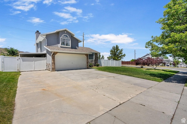 3774 S 8370 W, Magna, UT 84044 - traditional-style home featuring concrete driveway, a gate, a garage, stucco siding, and stone siding
