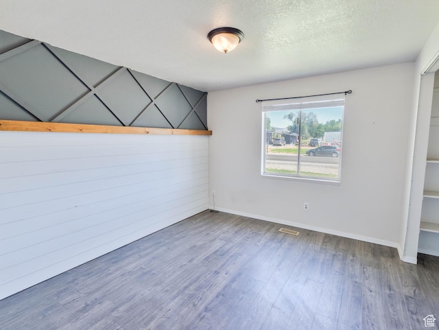 35 W 200 N, Aurora, UT 84620 - unfurnished bedroom with wood finished floors, baseboards, and a textured ceiling