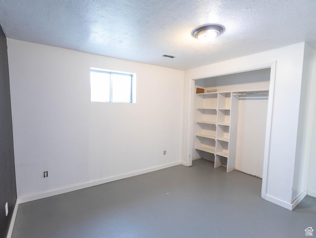 35 W 200 N, Aurora, UT 84620 - unfurnished bedroom featuring concrete flooring, a textured ceiling, baseboards, and a closet