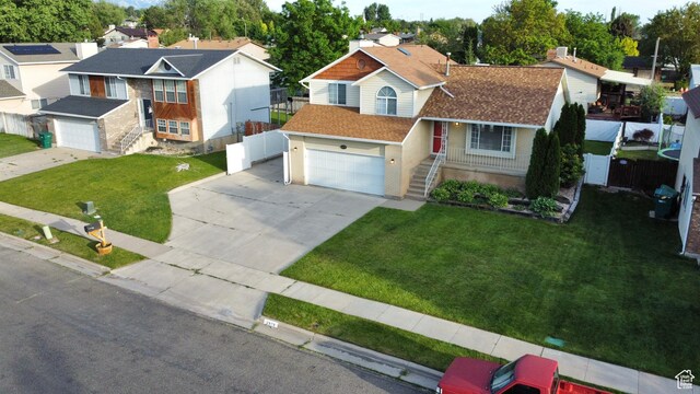 2979 W 4275 S, Roy, UT 84067 - view of front of home with driveway, a garage, a residential view, and a shingled roof