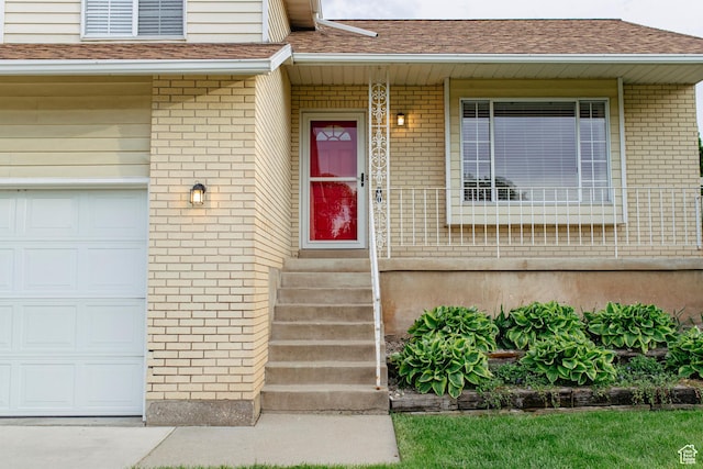 2979 W 4275 S, Roy, UT 84067 - doorway to property featuring brick siding, a shingled roof, and a porch