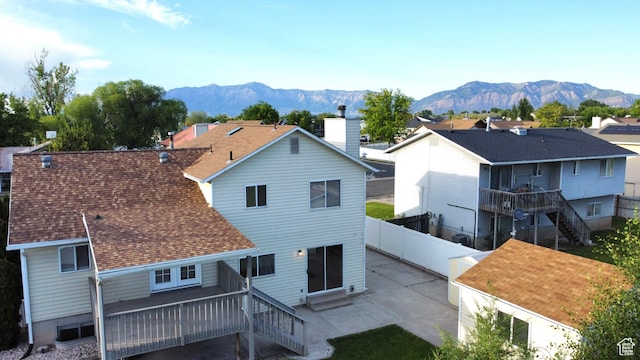2979 W 4275 S, Roy, UT 84067 - back of house featuring a patio, a fenced backyard, stairs, a shingled roof, and a chimney