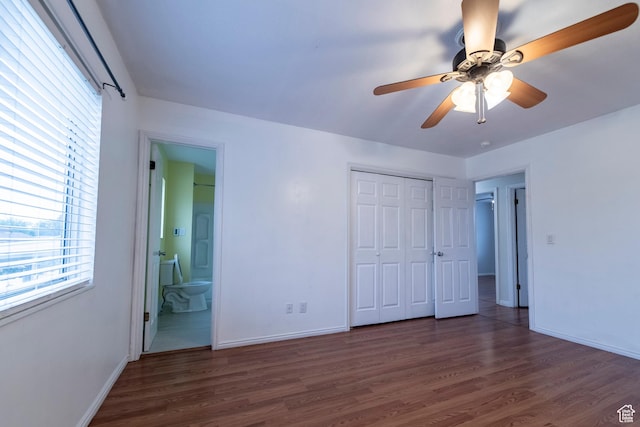 2979 W 4275 S, Roy, UT 84067 - unfurnished bedroom featuring multiple windows, wood finished floors, and baseboards