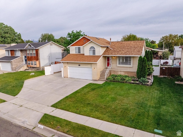 2979 W 4275 S, Roy, UT 84067 - split level home featuring driveway, an attached garage, roof with shingles, and stairs